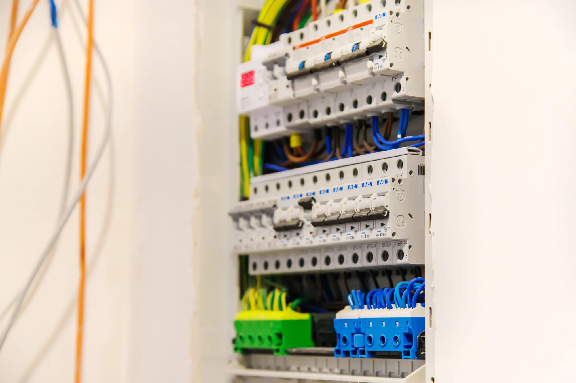 Electrician working inside a residential switchboard during a supply upgrade